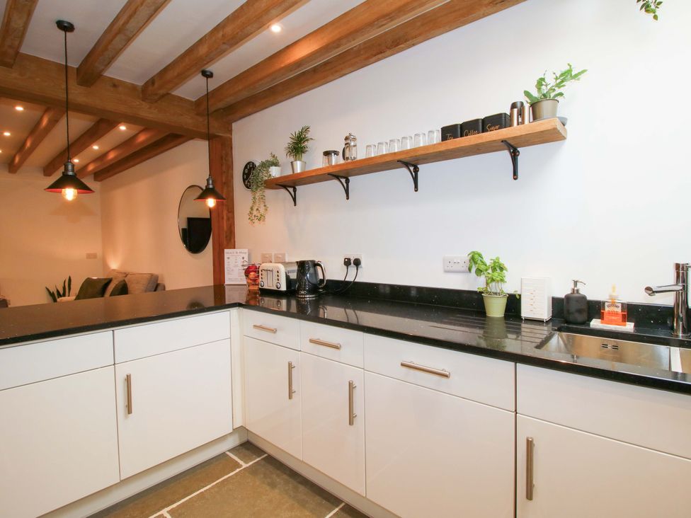 A kitchen with a counter and shelf at The Hideaway in Bishop's Castle