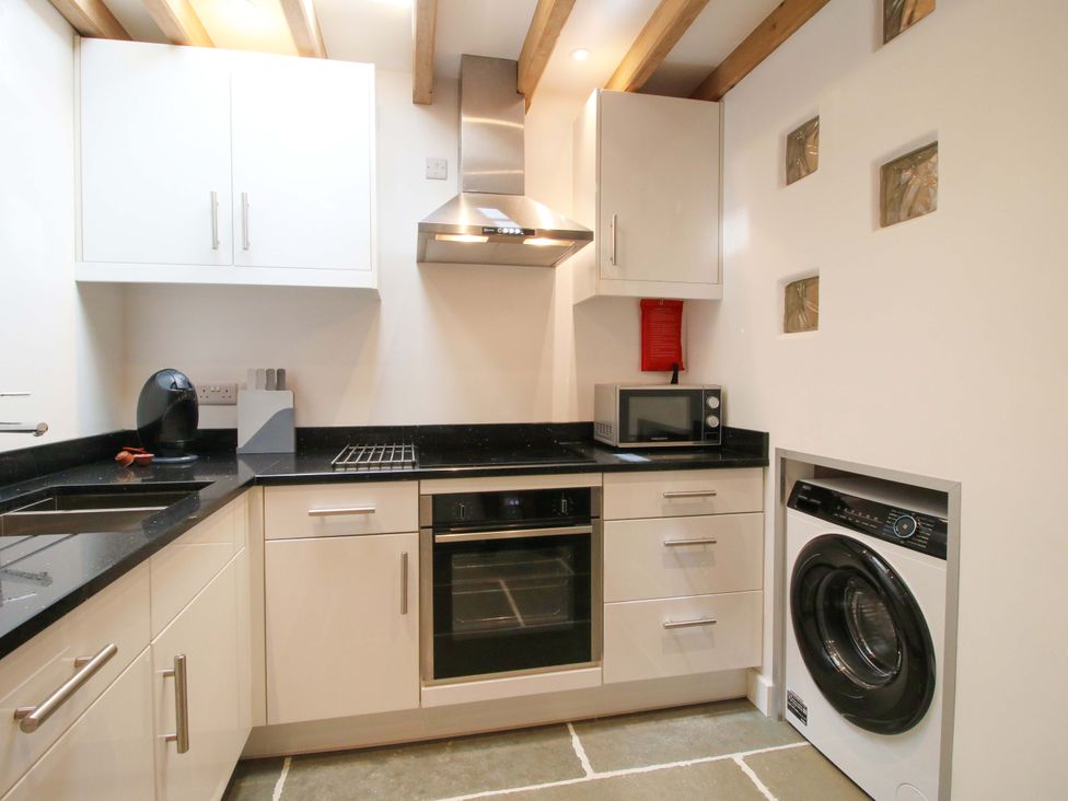 A kitchen with cabinets and appliances at The Hideaway in Bishop's Castle