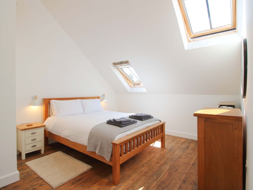 A bedroom with a bed and skylight at The Hideaway in Bishop's Castle
