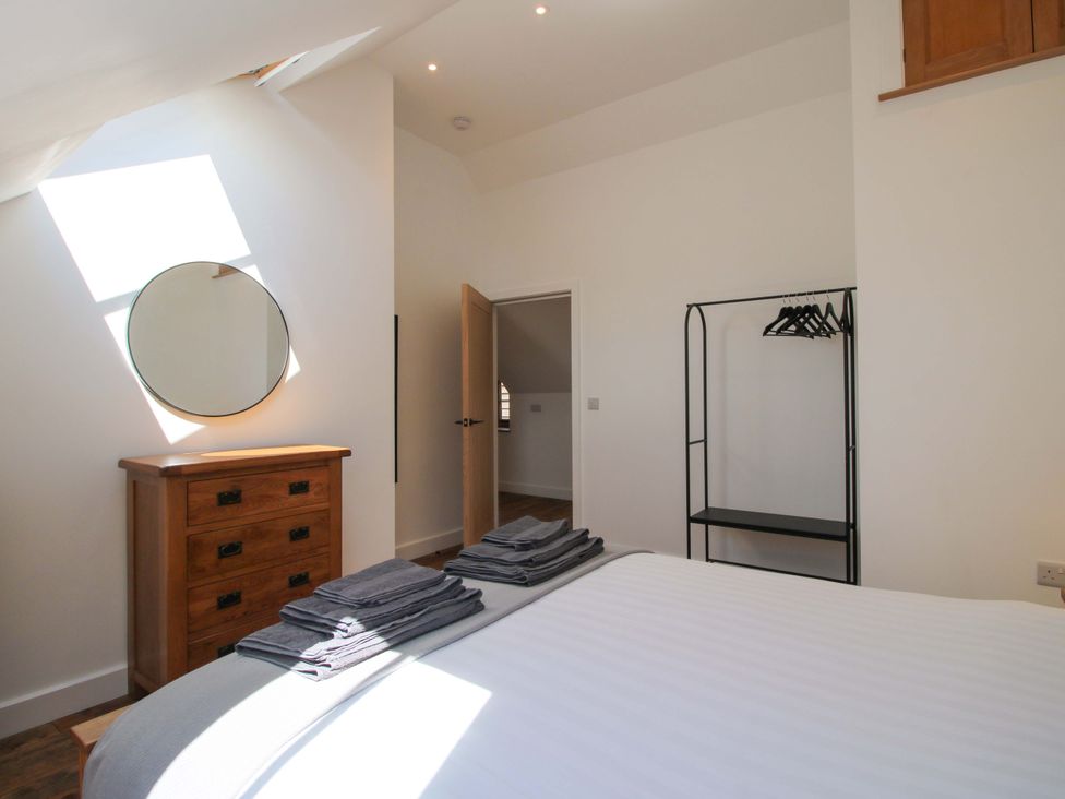 A bedroom with a bed and towels on it at The Hideaway in Bishop's Castle
