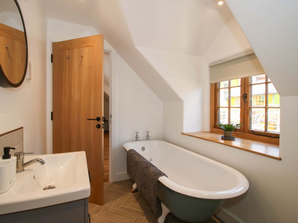 A bathroom with a bathtub and sink at The Hideaway in Bishop's Castle