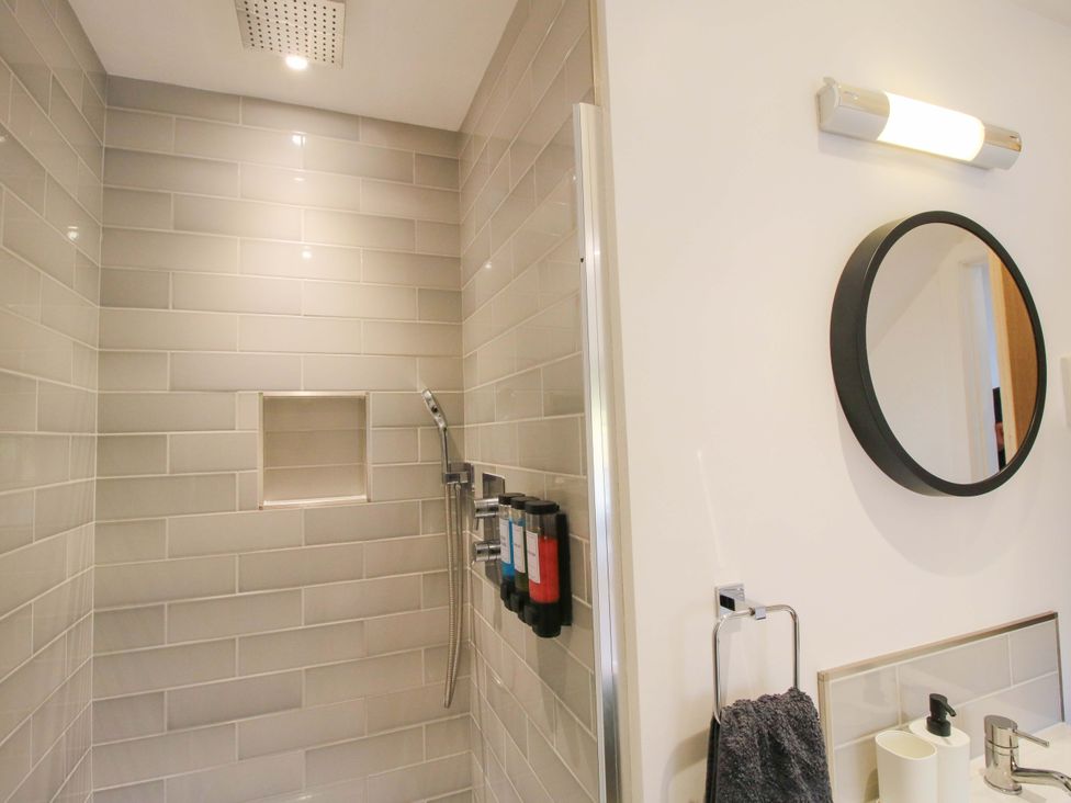 A bathroom with a shower and a mirror at The Hideaway in Bishop's Castle
