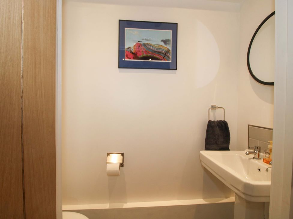 A bathroom with a sink and toilet at The Hideaway in Bishop's Castle