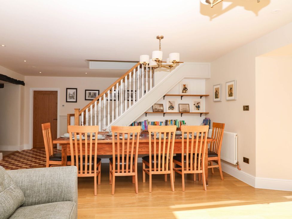 A dining room with a table and chairs at Higher Weekaborough Farm, Coombe Fishacre near Ipplepen