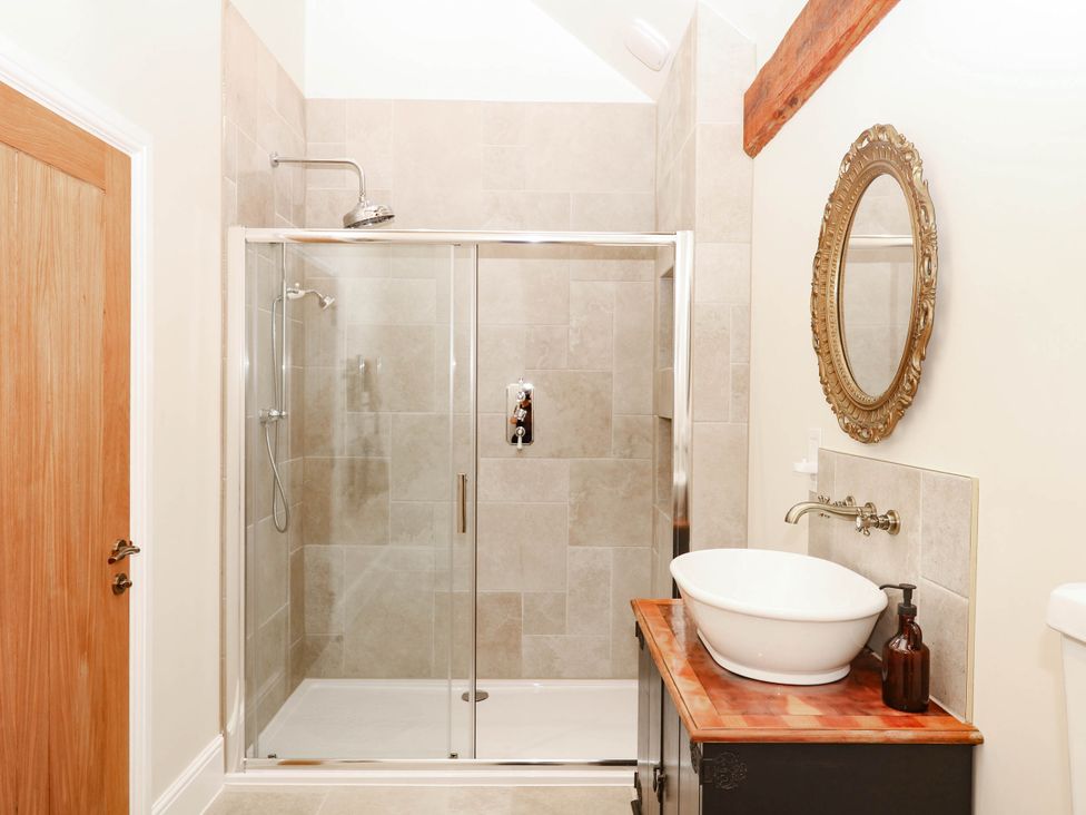 A bathroom with a shower and sink at Higher Weekaborough Farm in Coombe Fishacre near Ipplepen