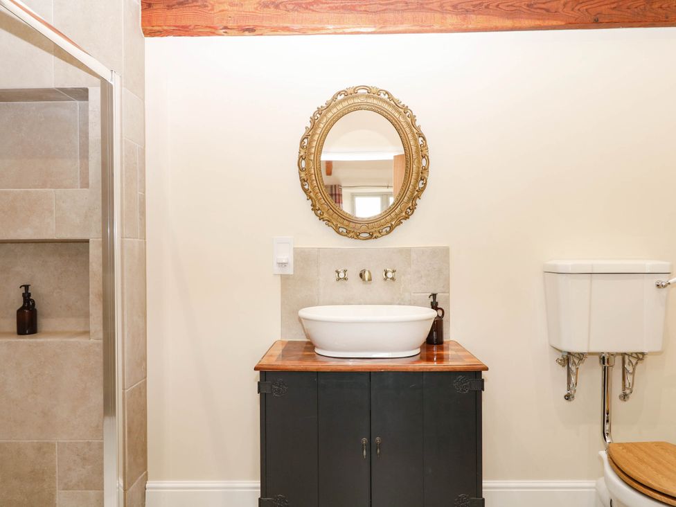 A bathroom with a sink and mirror at Higher Weekaborough Farm near Ipplepen