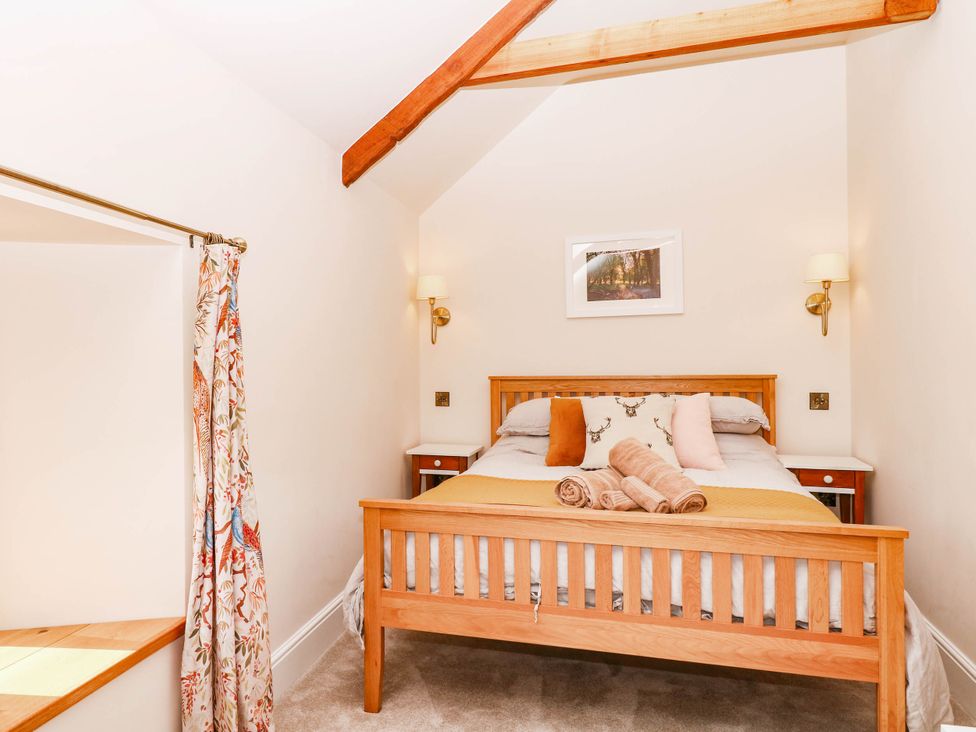 A bedroom with a bed and bedside table at Higher Weekaborough Farm near Coombe Fishacre near Ipplepen