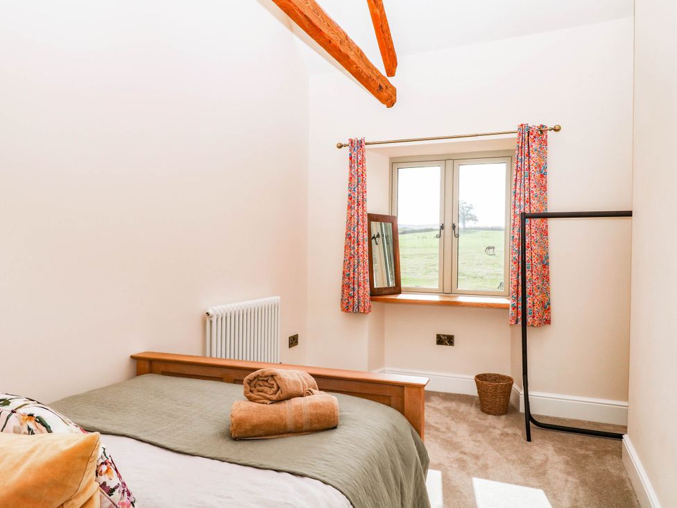 A bedroom with a bed and window at Higher Weekaborough Farm near Coombe Fishacre near Ipplepen