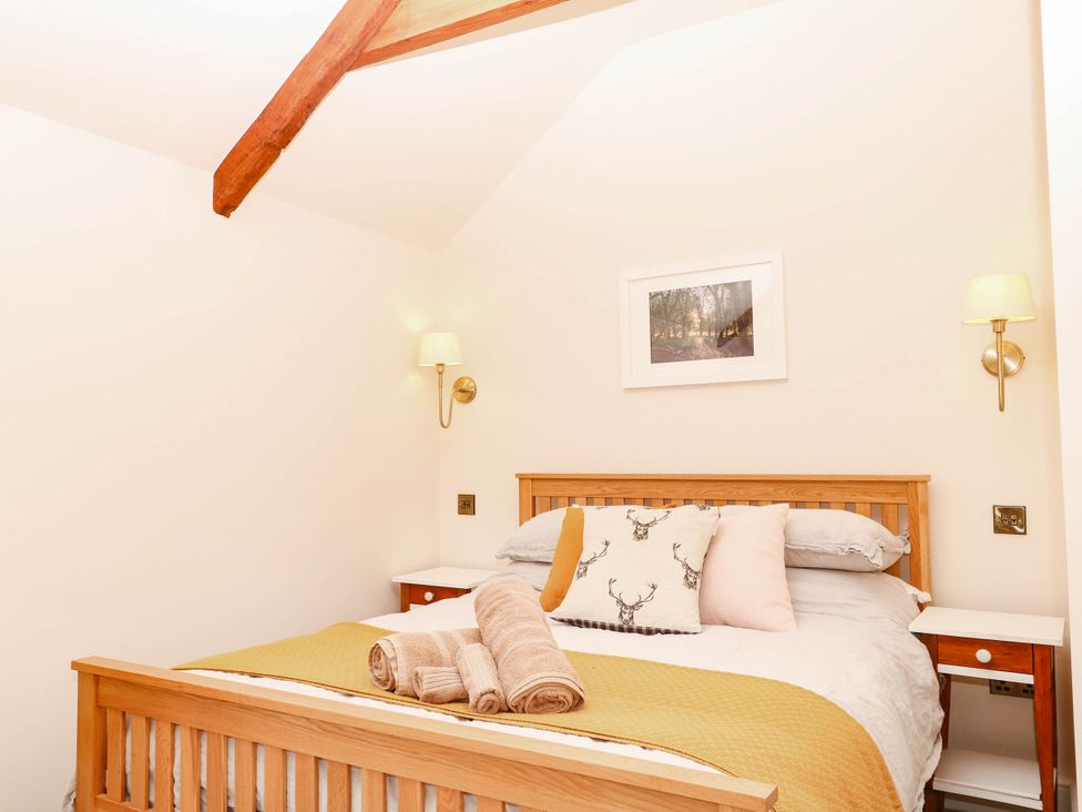 A bedroom with a bed and a picture on the wall at Higher Weekaborough Farm near Coombe Fishacre Ipplepen