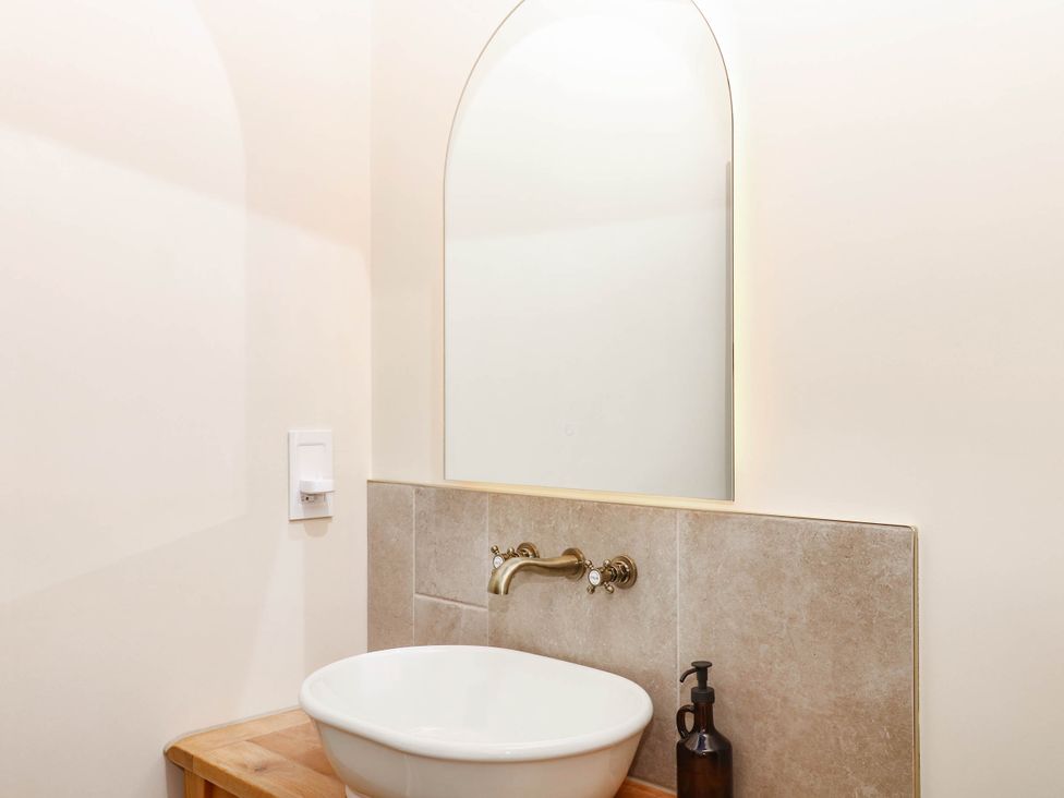 A bathroom with a sink and mirror at Higher Weekaborough Farm Coombe Fishacre near Ipplepen