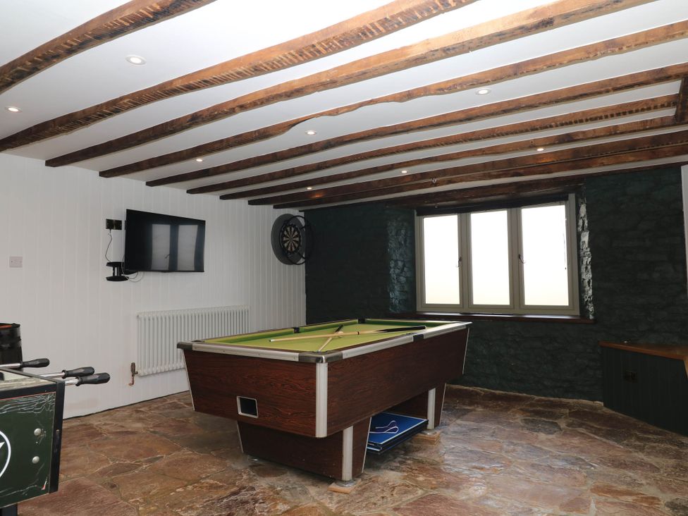 A game room with a pool table and a television at Higher Weekaborough Farm near Coombe Fishacre Ipplepen
