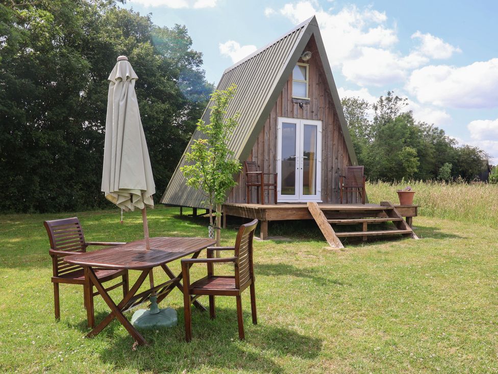 A-frame house with table and chairs in a garden at A-frame in Monewden near Otley, Suffolk
