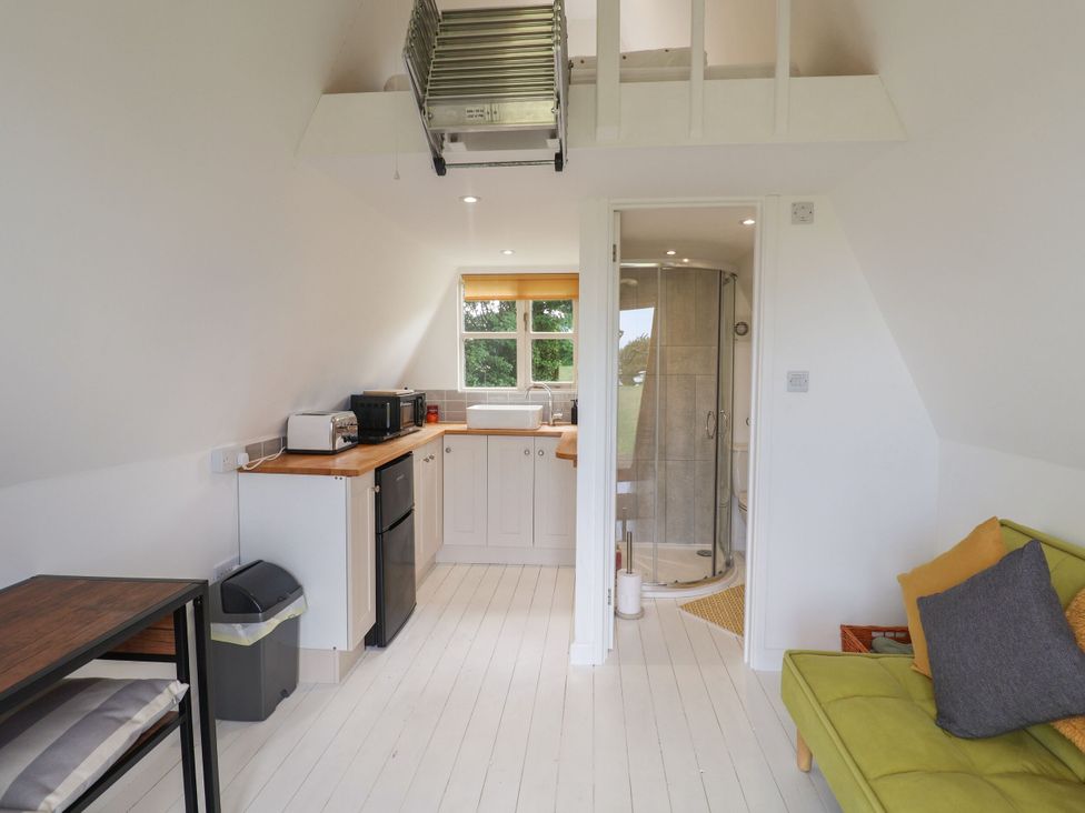 A kitchen with a sofa and shower at A-frame in Monewden near Otley, Suffolk