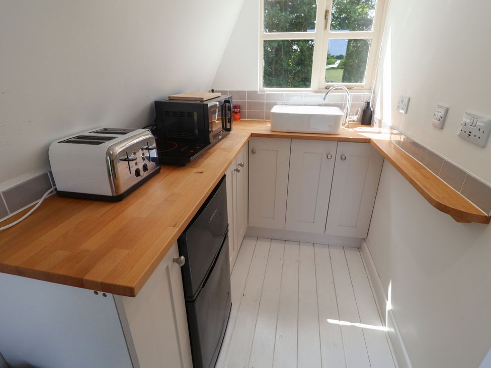 A kitchen with a toaster, microwave, sink, and cabinets at A-frame in Monewden near Otley, Suffolk