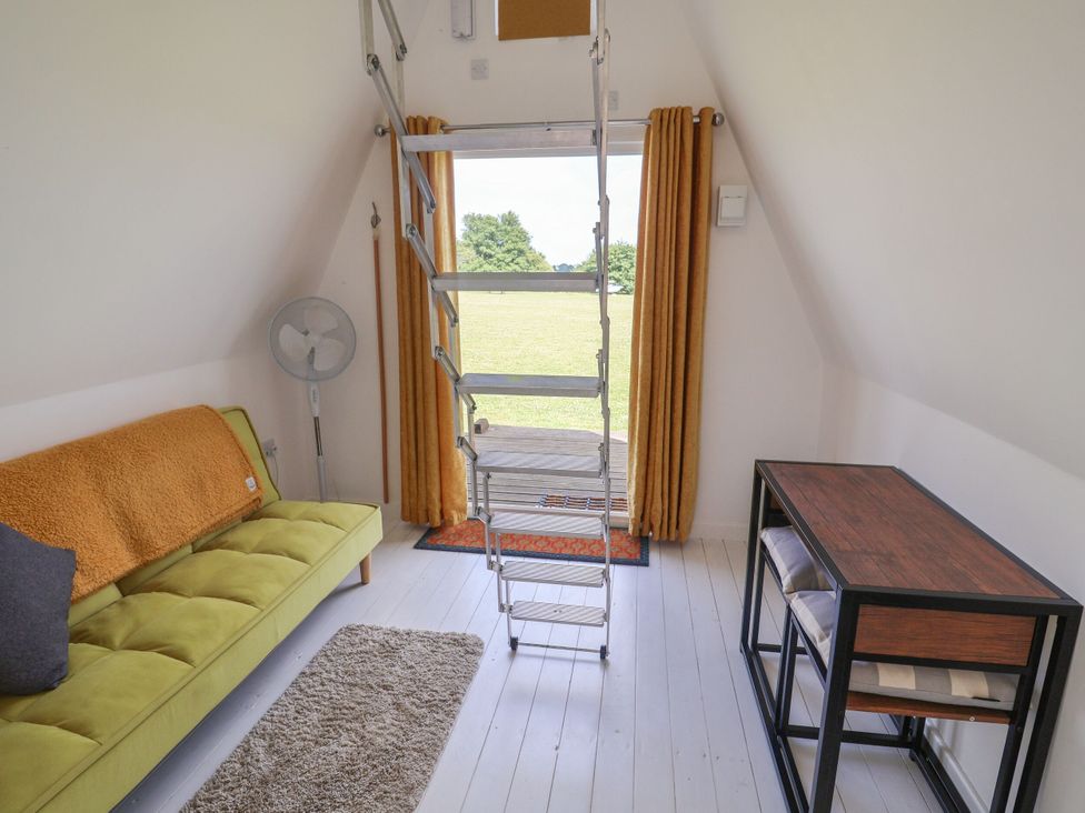 A seating area with a ladder and table at A-frame Monewden near Otley Suffolk