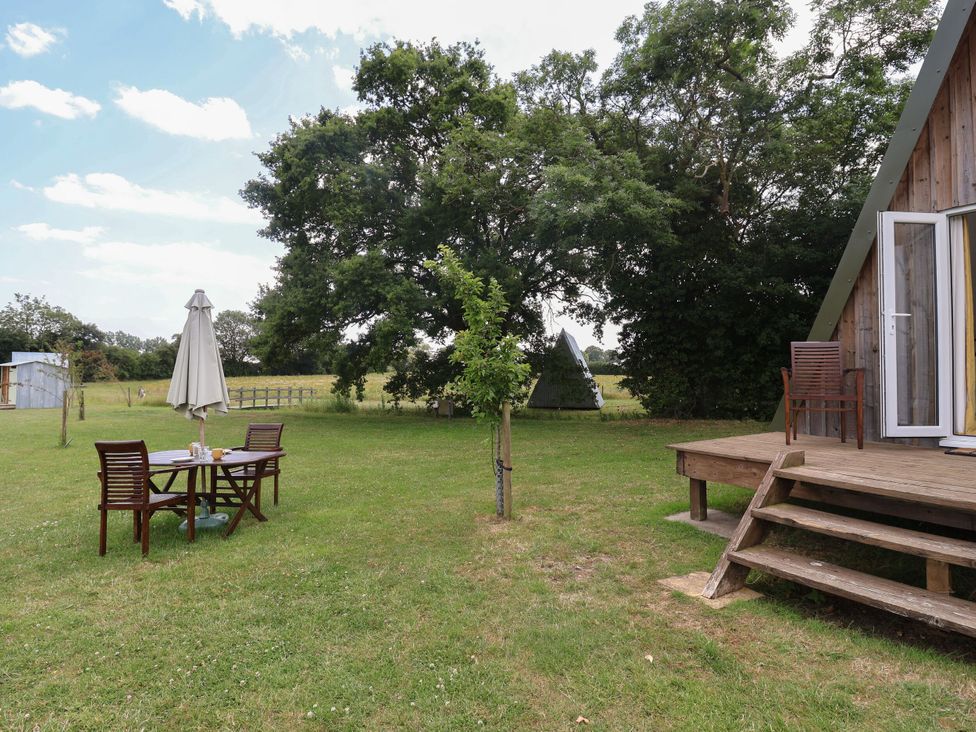 An outdoor seating area with a table and chairs at A-frame Monewden near Otley, Suffolk