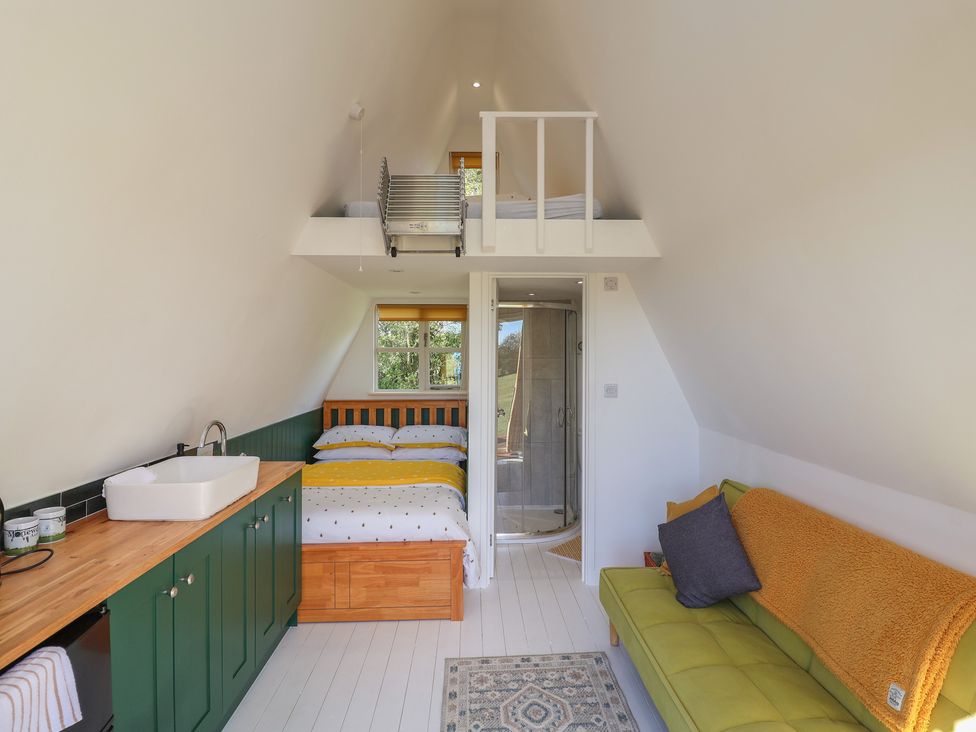 A studio with a bed, sink, and shower at A-frame in Monewden near Otley, Suffolk