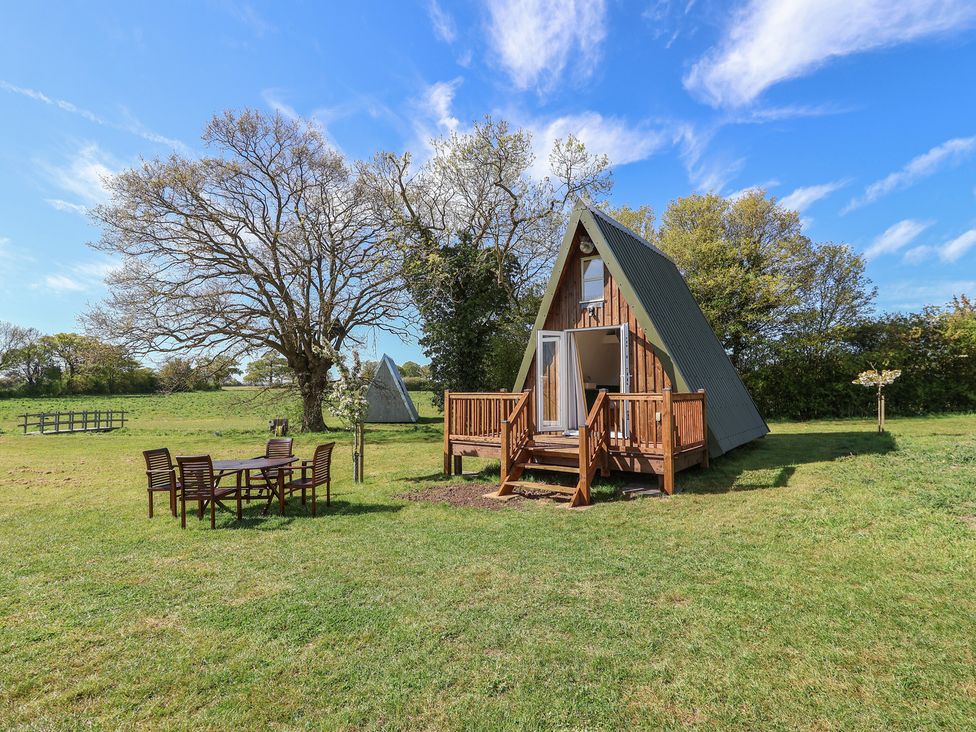 Outdoor area with A-frame cabin and seating at A-frame Monewden near Otley, Suffolk