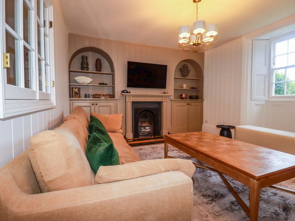 A living room with a sofa and coffee table at Vosporth Villa in Newquay