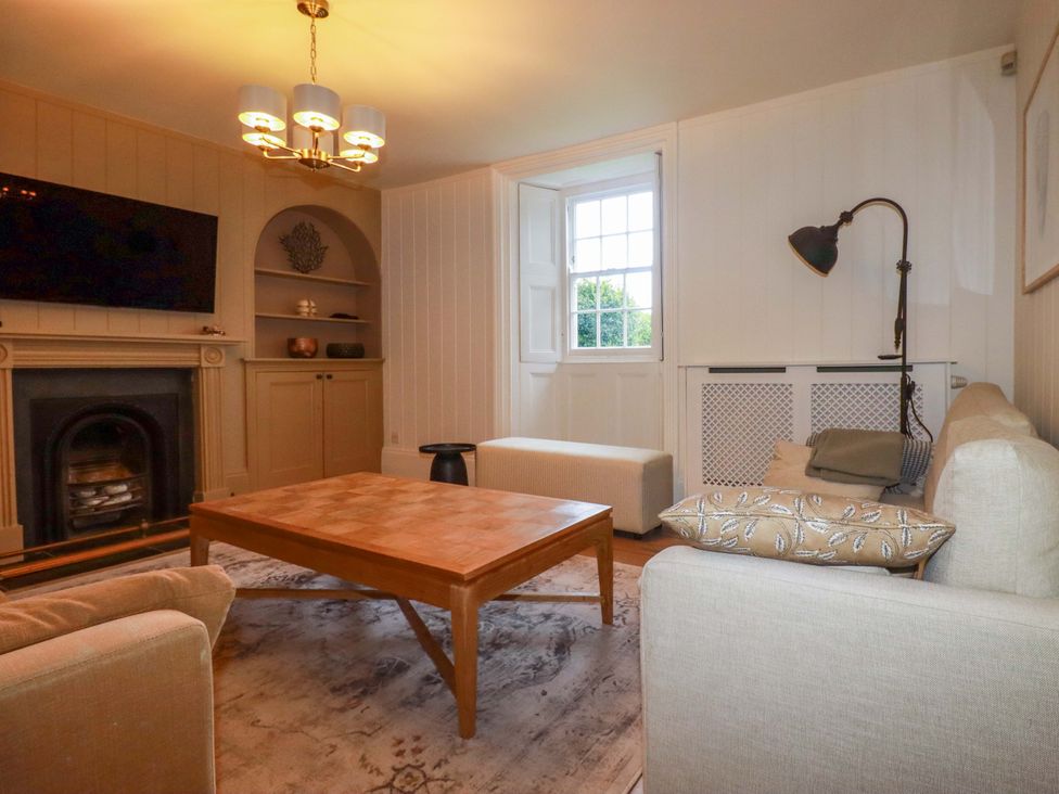 A living room with a coffee table and a sofa at Vosporth Villa in Newquay