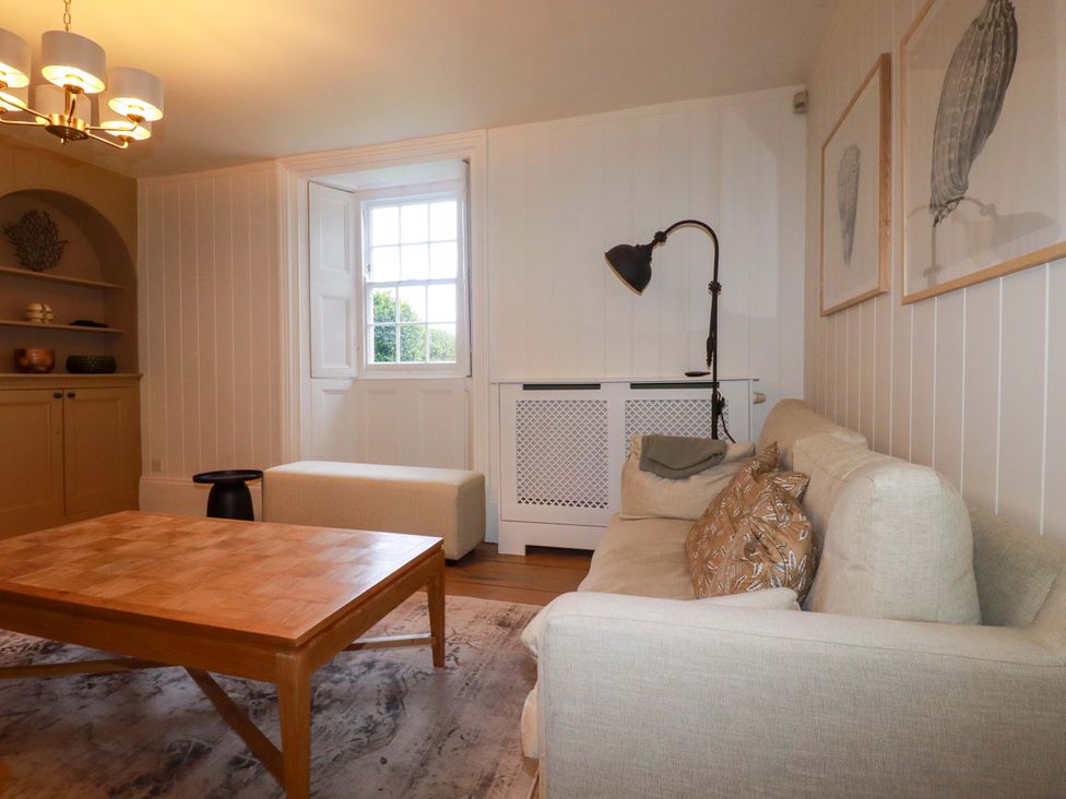 A living room with a sofa and coffee table at Vosporth Villa in Newquay