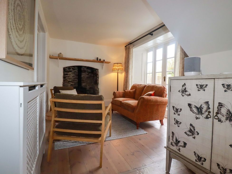 A living room with a sofa and armchairs at Vosporth Villa in Newquay