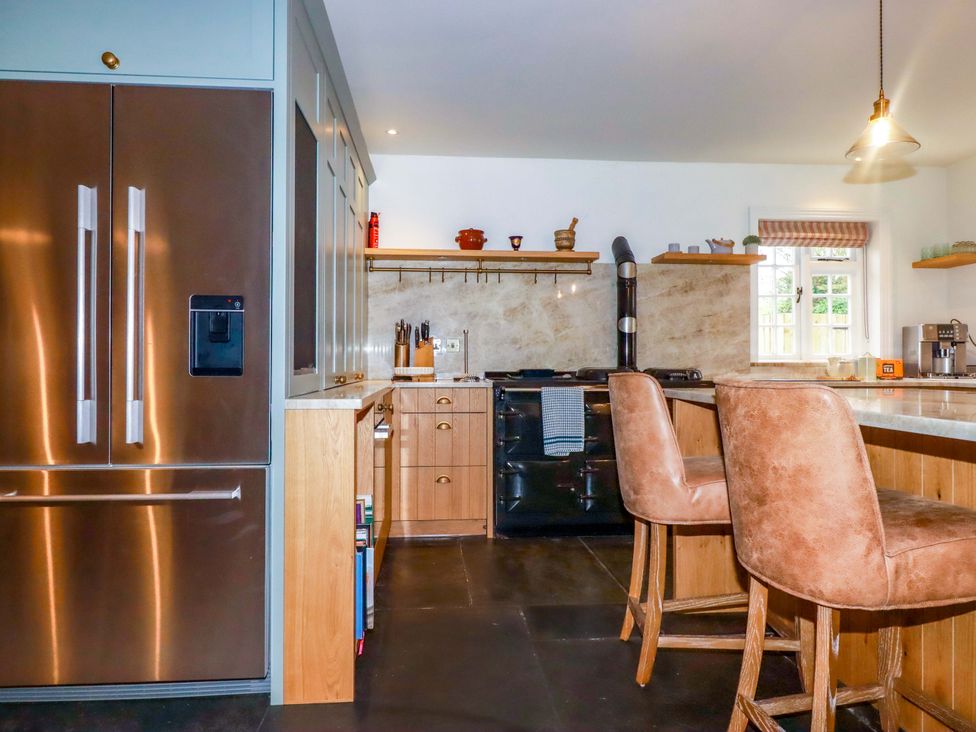 A kitchen with a refrigerator and stove at Vosporth Villa in Newquay