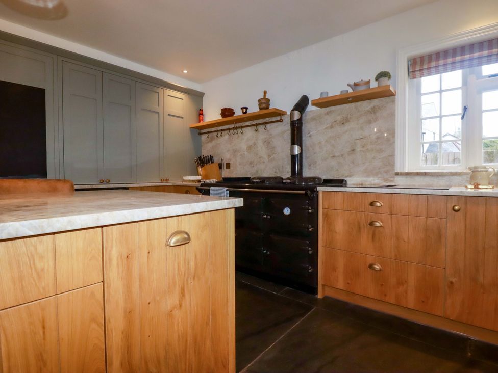 A kitchen with cabinets and a stove at Vosporth Villa in Newquay