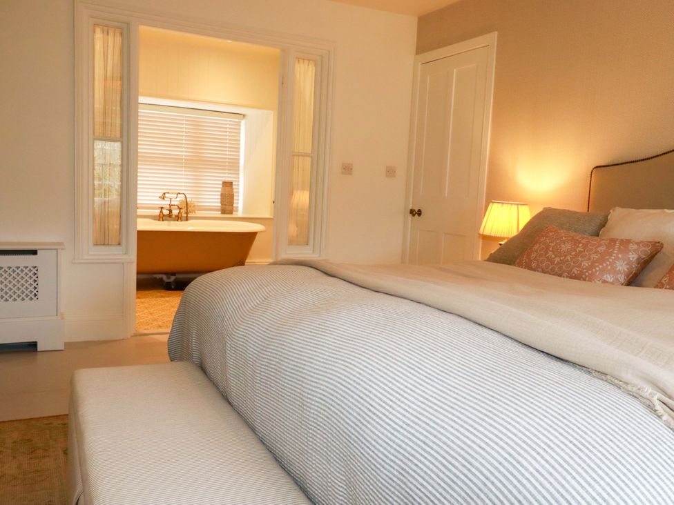 A bedroom with a view of a bathroom at Vosporth Villa Newquay