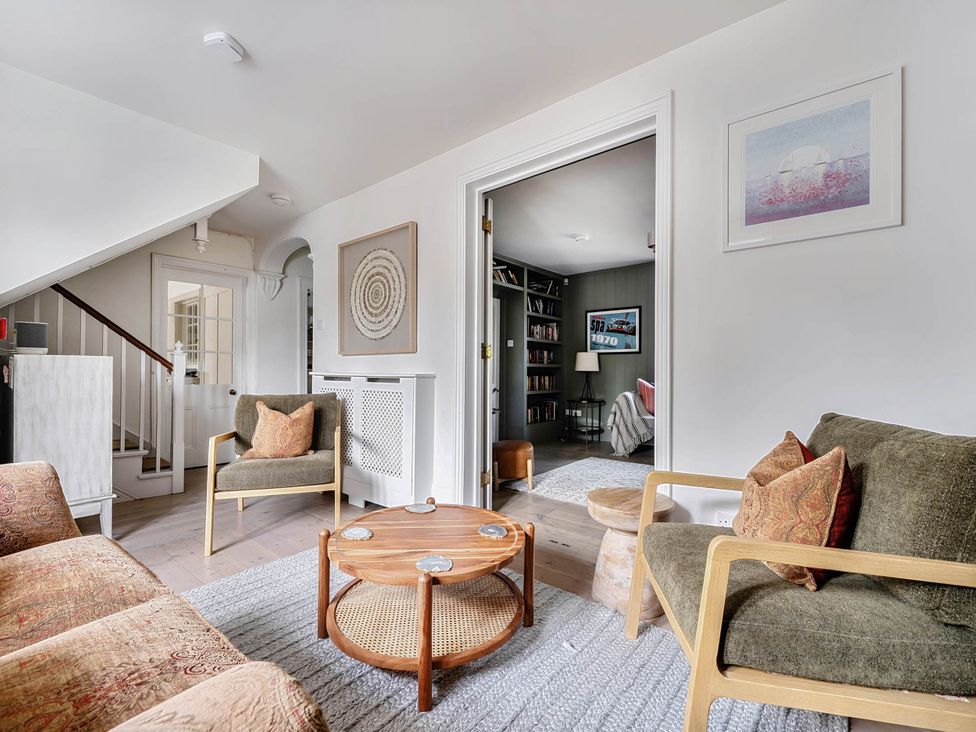 A living room with a sofa and coffee table at Vosporth Villa in Crantock