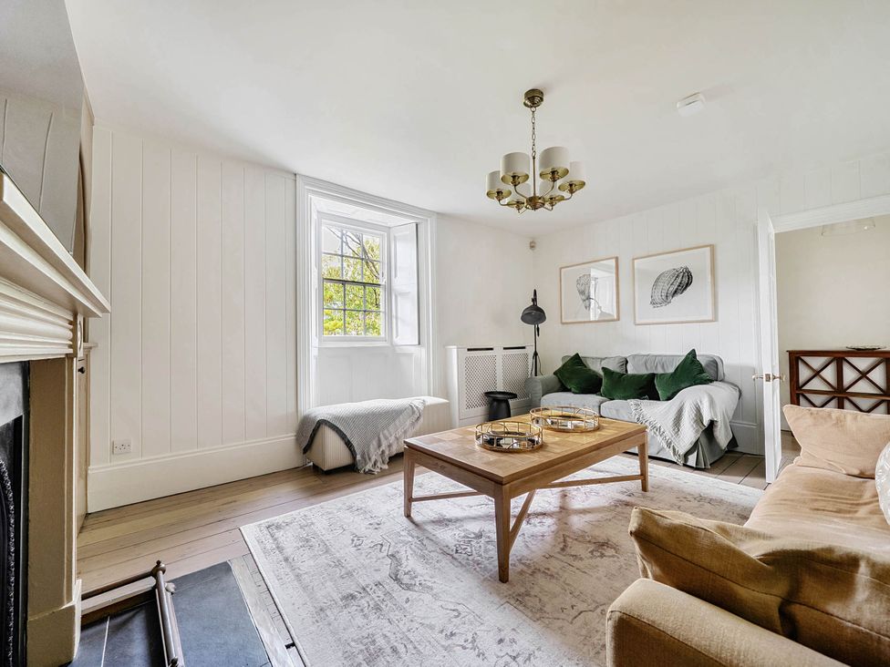 A living room with a coffee table and sofa at Vosporth Villa in Crantock