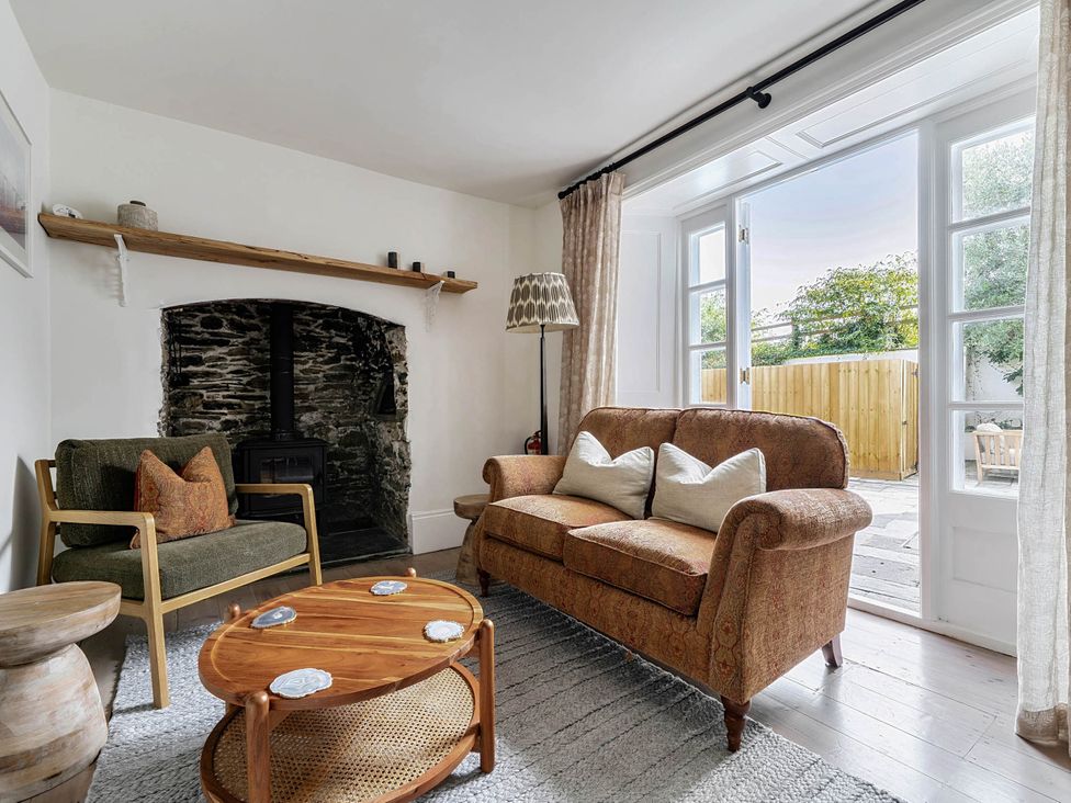 A living room with a sofa and coffee table at Vosporth Villa in Crantock