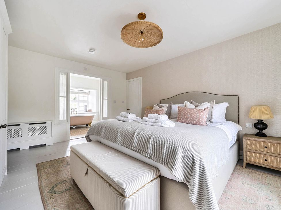A bedroom with a bed and furniture at Vosporth Villa Crantock