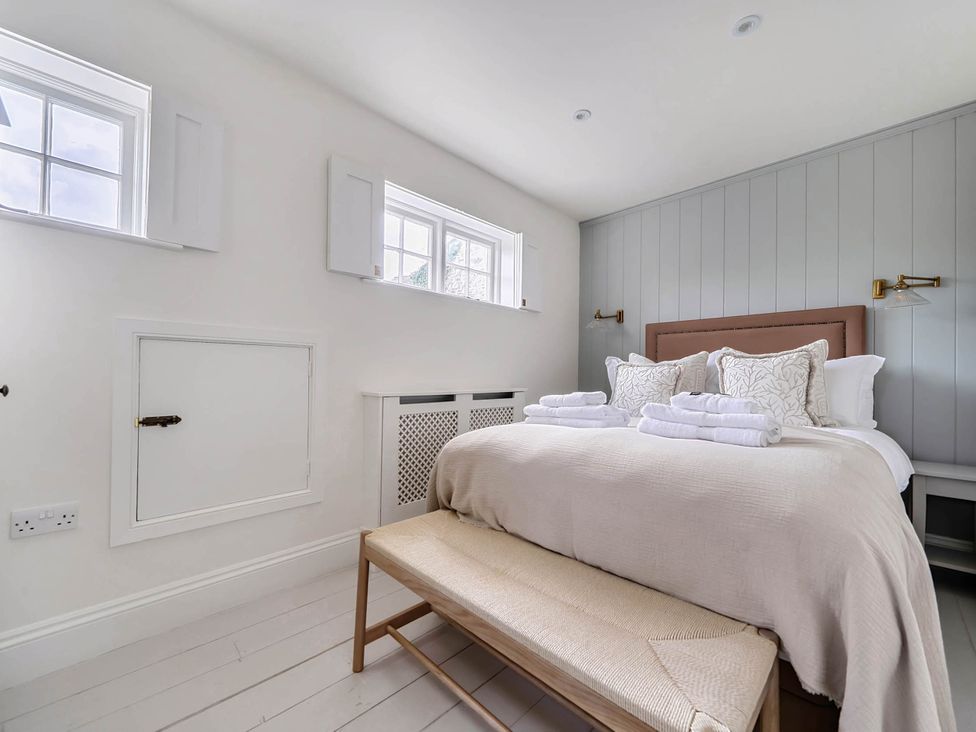 A bedroom with a bed and bedside table at Vosporth Villa in Crantock