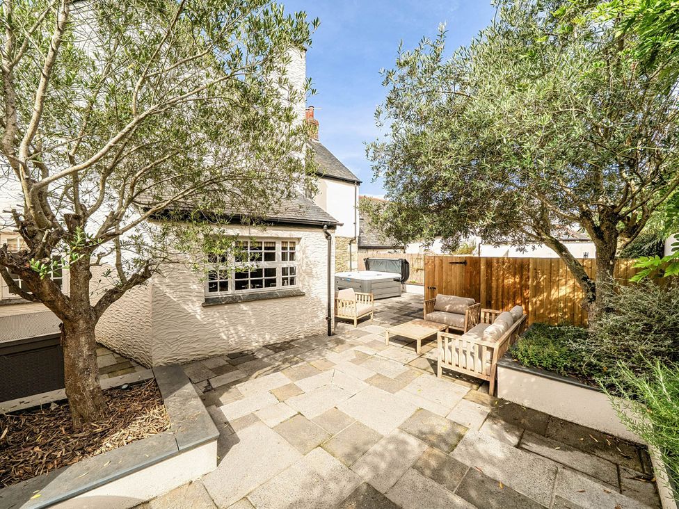 An outdoor area with seating and a hot tub at Vosporth Villa in Crantock