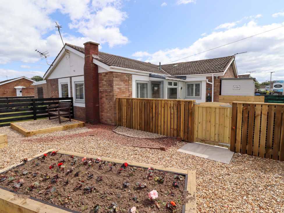 A bungalow with a garden and a flower bed at North Sands in Beadnell