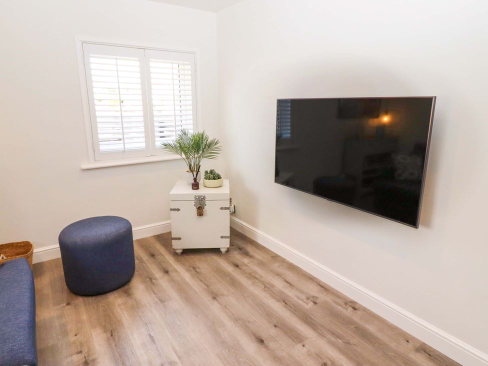 A living room with a TV and coffee table at North Sands Beadnell