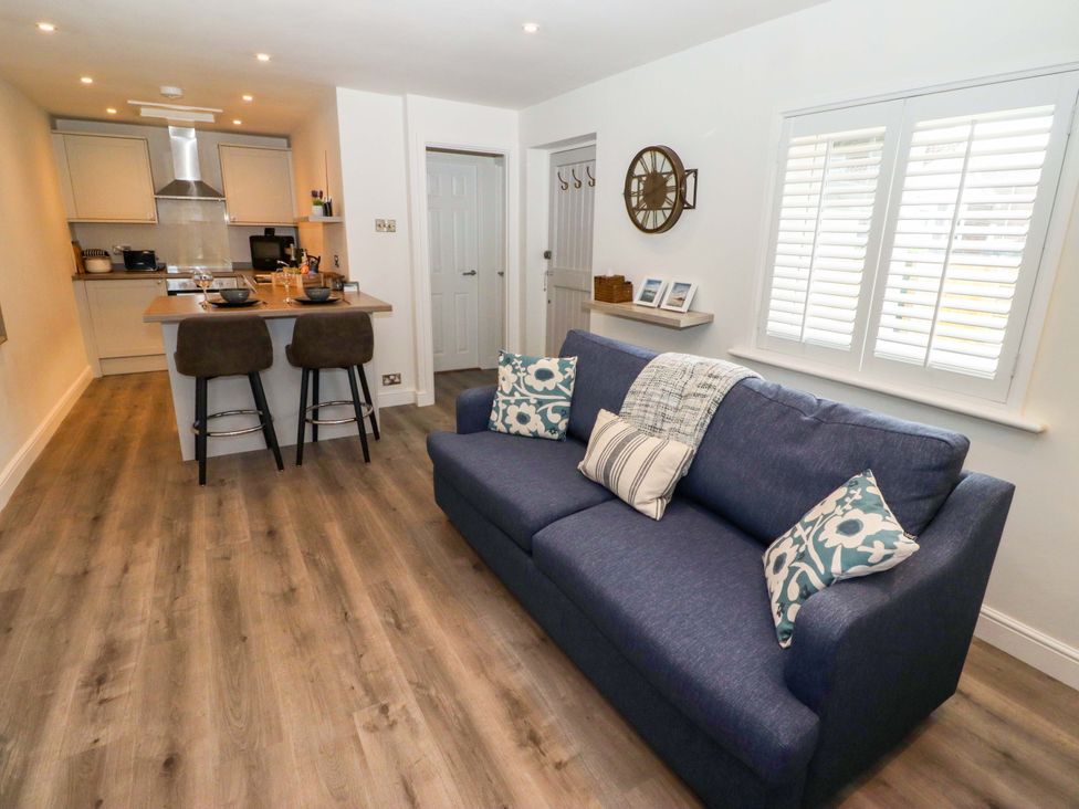 A living room with a sofa and kitchen island at North Sands Beadnell
