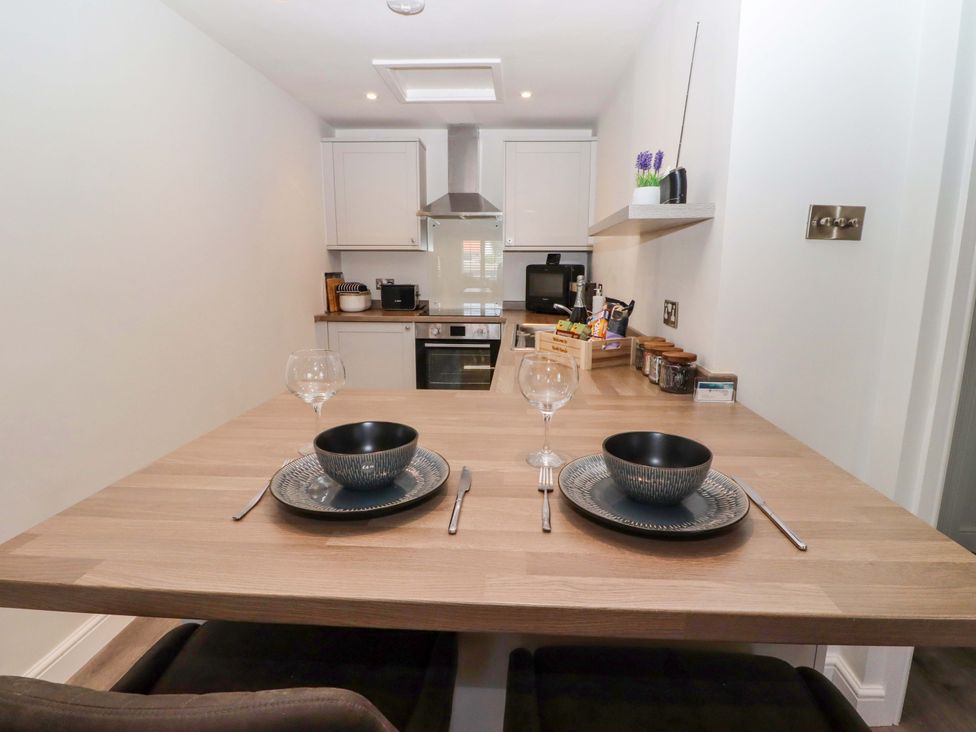A kitchen with a dining table set for two at North Sands in Beadnell