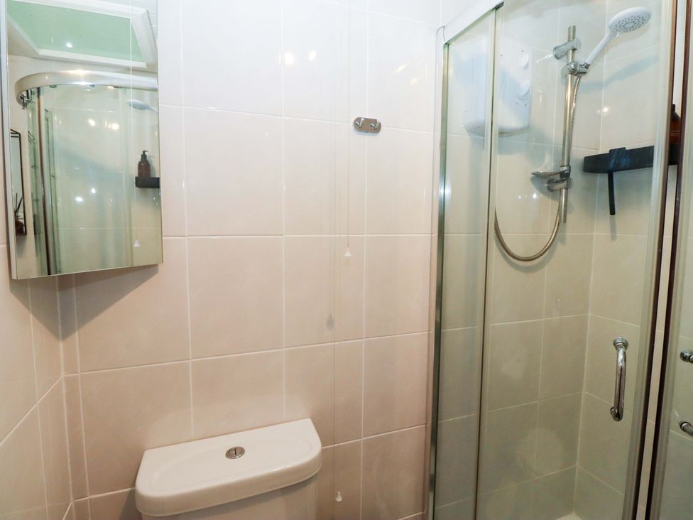 A bathroom featuring a shower and a toilet at North Sands Beadnell