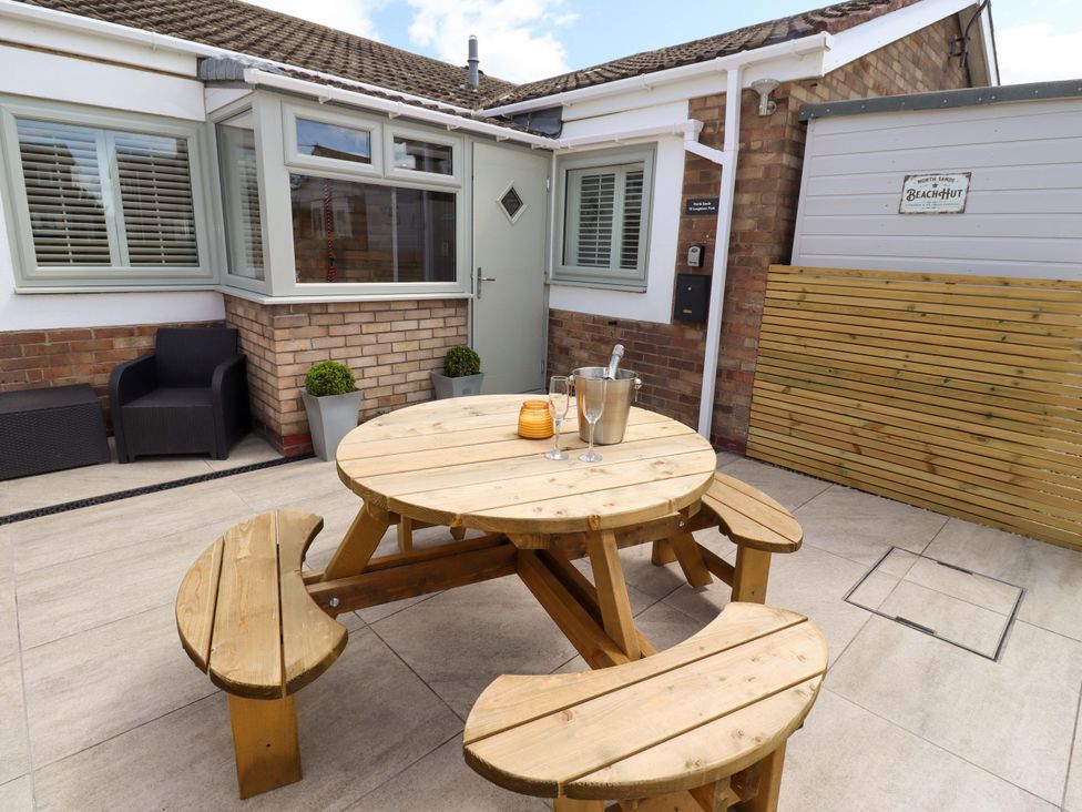 An outdoor seating area with a table and benches at North Sands Beadnell