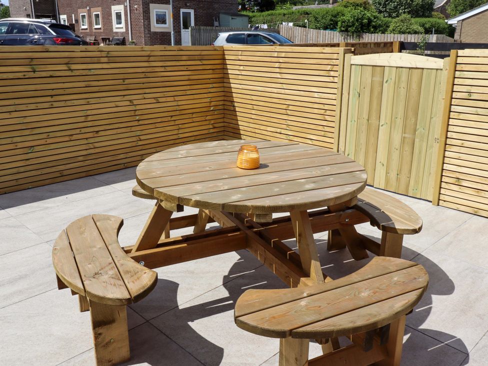 A table with benches in an outdoor area at North Sands Beadnell
