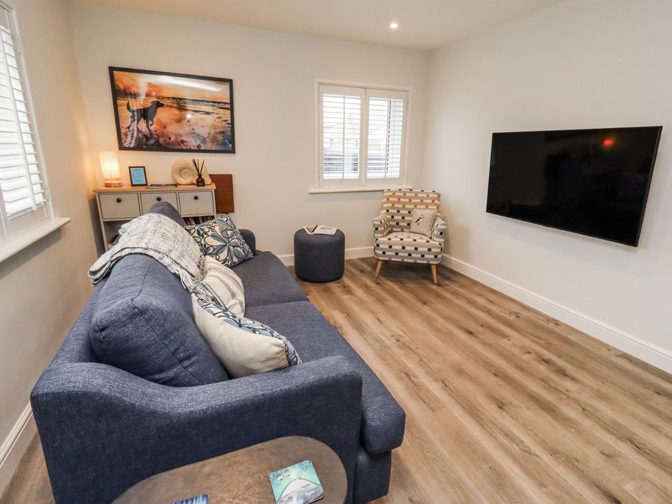 A living room with a television and a sofa at North Sands in Beadnell