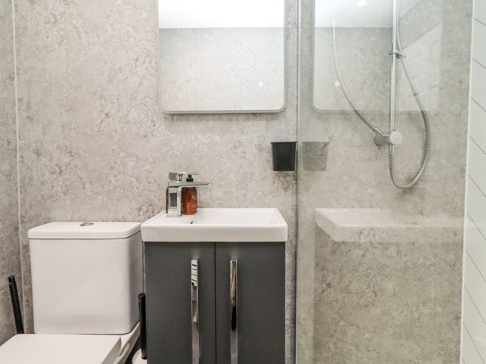A bathroom with a sink and shower at North Sands in Beadnell