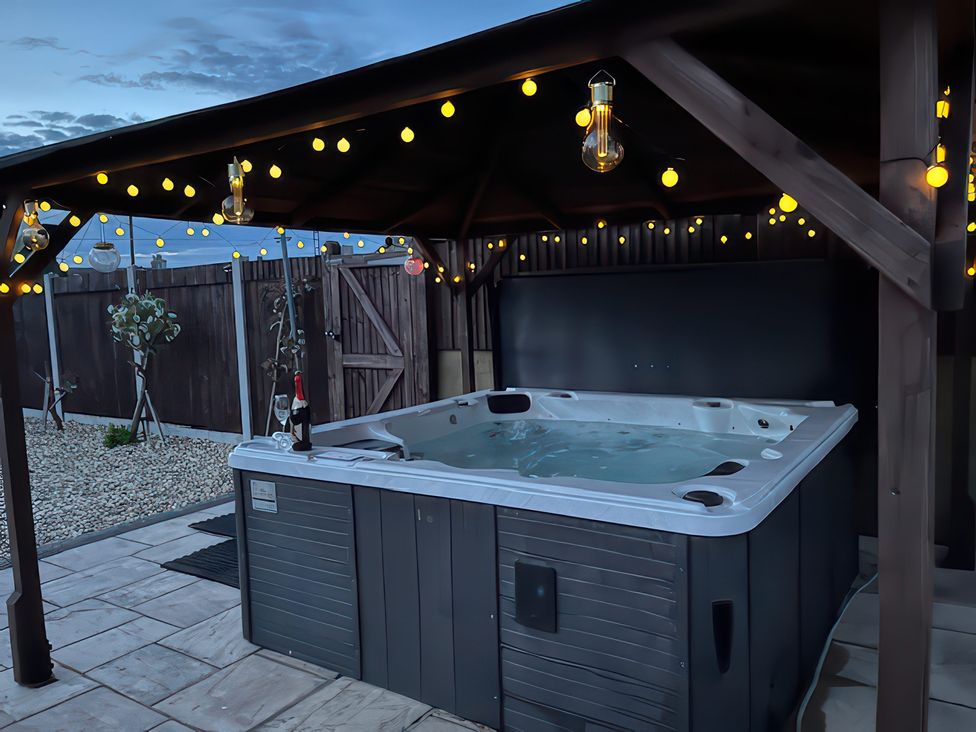 A hot tub surrounded by lights in an outdoor area at Marine House Pevensey Bay