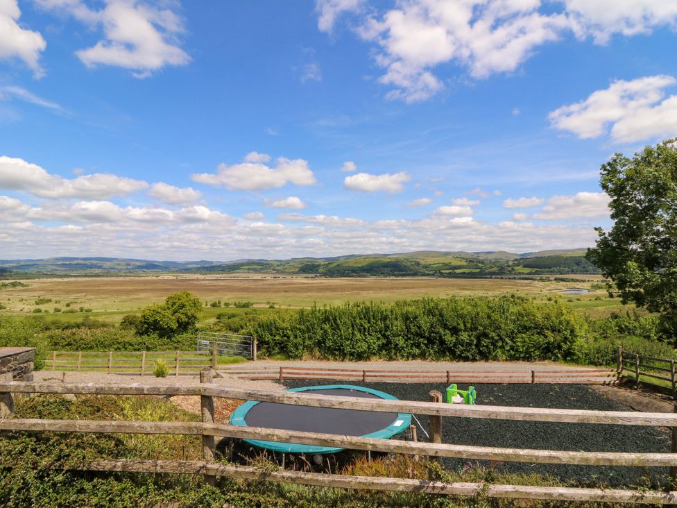 A view of hills and a trampoline at Llwyngwinau Isaf Barn Tynreithyn near Tregaron
