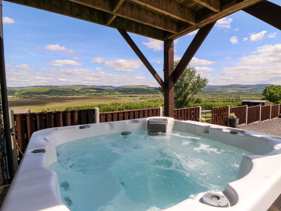 A hot tub with a scenic view at Llwyngwinau Isaf Barn in Tynreithyn near Tregaron