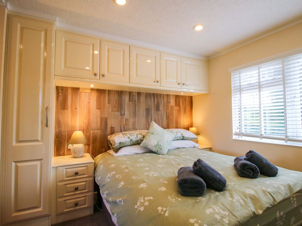 A bedroom with a bed and storage cabinet at Dunromin in Montgomery