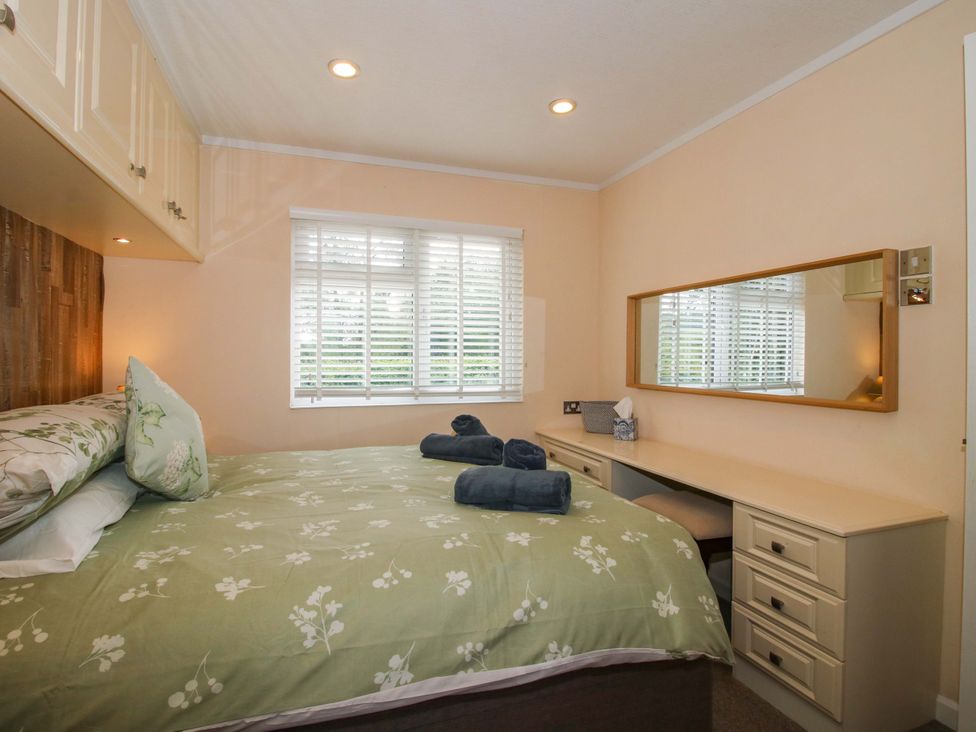 A bedroom with a bed and desk at Dunromin in Montgomery