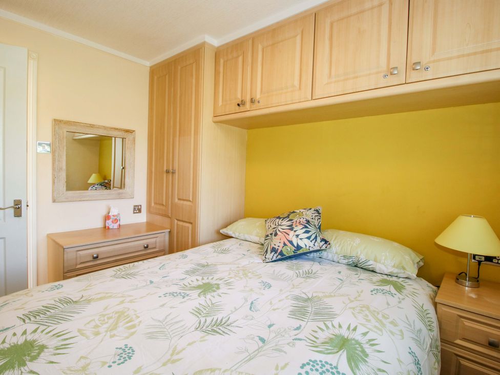 A bedroom with a bed and mirror at Dunromin in Montgomery